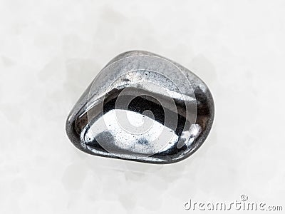 tumbled hematite gem on white marble Stock Photo