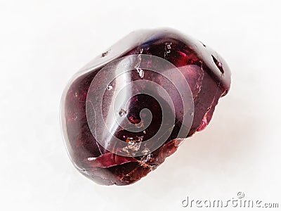 tumbled red garnet gemstone on white Stock Photo