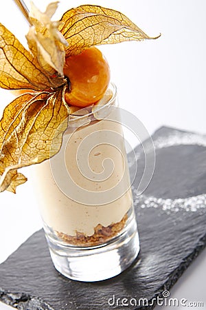 Macro Shot of Cheesecake in High Glass Decorated with Physalis Stock Photo