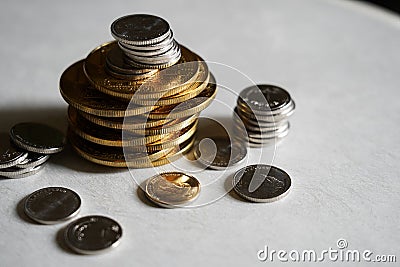 Macro shot detail of golden and silver color coin stacks on dark Stock Photo