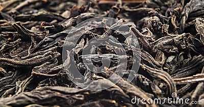 Macro shot of a high quality black tea. Black tea background close up. Leaf closeup. Background of dried tea leaves of dark color. Stock Photo