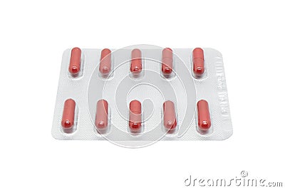 Macro shot pile of red tablets pill in silver blister packaging isolated on white background. Aluminium foil blister pack. Stock Photo