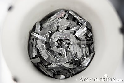 Macro shot of pure zinc telluride element crystals in a container Stock Photo