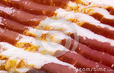 Macro shot several rows of sliced smoked bacon isolated on white background. Fresh sliced bacon isolated over white background. Ra Stock Photo