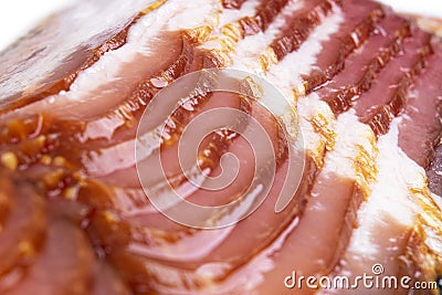 Macro shot several rows of sliced smoked bacon isolated on white background. Fresh sliced bacon isolated over white background. Ra Stock Photo