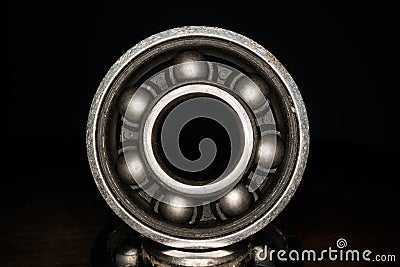 Macro shot of stainless steal bearing. New replacement roller skate bearings isolated on black background. Standard ABEC type Stock Photo