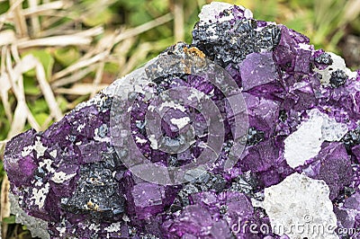 Macro shot of vivid purple fluorite crystals with rich color contrast on a dark background Stock Photo