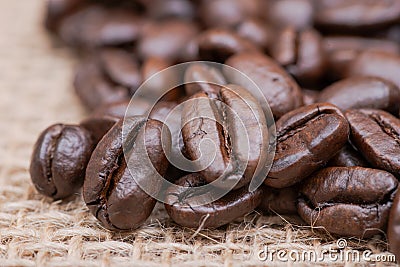 Macro shot of whole bean organic smooth medium dark roast coffee from Sumatra on burlap Stock Photo