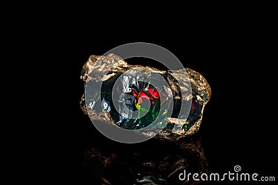 Macro stone Opal mineral in rock on a black background Stock Photo