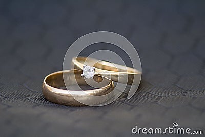 Wedding rings. ring with breients. Gray background. gray honeycomb. macro. macro two rings. macro two rings. Stock Photo