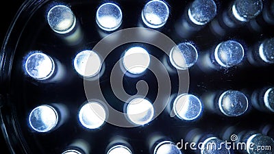 Macro view of lit LED lamps of a portable flashlight in perspective Stock Photo
