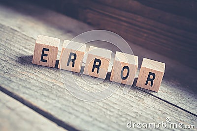 Macro Of The Word Error Formed By Wooden Blocks On A Wooden Floor Stock Photo