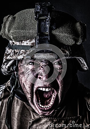 Mad army soldier screaming while looking at camera Stock Photo