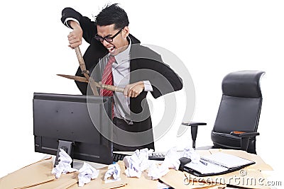Mad businessman cutting computer Stock Photo