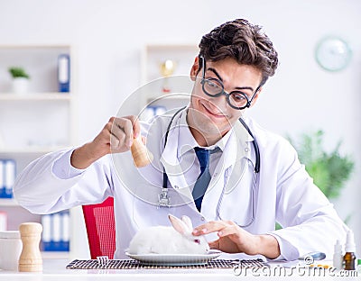 Mad crazy doctor preparing to eat rabbit Stock Photo