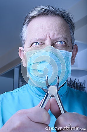 Mad dentist with pliers in his hands Stock Photo