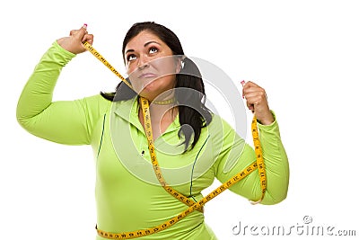 Mad Hispanic Woman Tied Up With Tape Measure Stock Photo