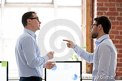 Mad male colleague blame coworker for business failure Stock Photo