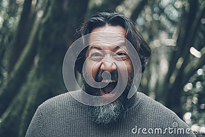 Mad mature man shouting crazy at the camera. Stressed people portrait concept life. Bearded young senior man shout with craziness Stock Photo