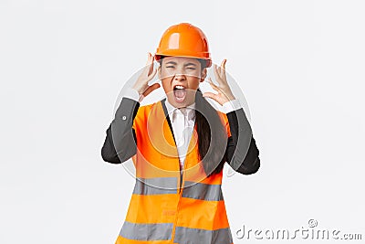 Mad and outraged asian female chief engineer, construction manager burst in rage, losing temper at employees, shouting Stock Photo