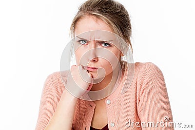 Mad young blond woman sulking, frowning her exasperation Stock Photo