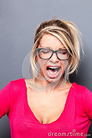 Mad young blond woman shouting her exasperation Stock Photo