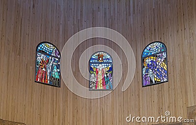 Stained glass windows hang on the wall in the prayer hall of Memorial Church of Moses on Mount Nebo near the city of Madaba in Jor Editorial Stock Photo