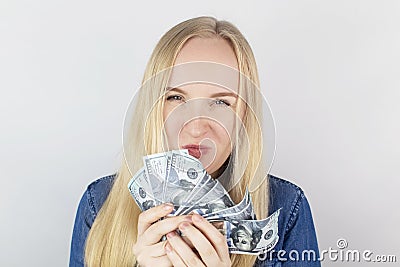 Close-up of a girl sniffing money. Madness and greed from currency. The concept of corruption and getting money at any cost. Stock Photo