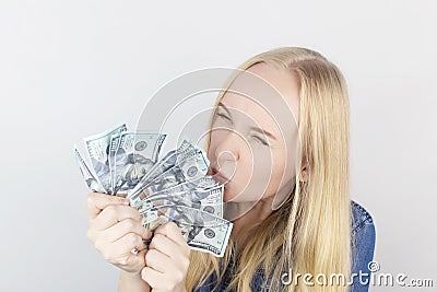 Close-up of a girl sniffing money. Madness and greed from currency. The concept of corruption and getting money at any cost. Stock Photo