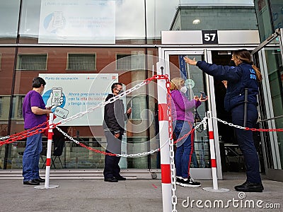 Mature people patients wearing face protective masks waiting in queue for vaccination against covid Editorial Stock Photo