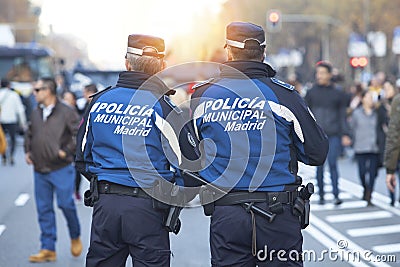 Policemen patrol on the Castellana Avenue and sunlight Editorial Stock Photo