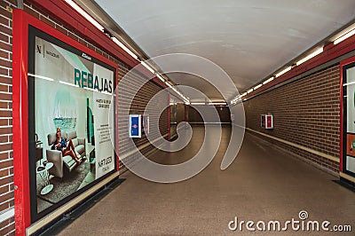 Advertising in passageway linking stations at the Madrid Subway Editorial Stock Photo