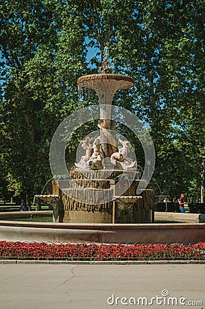 Fountain with statues and bushes in a park of Madrid Editorial Stock Photo