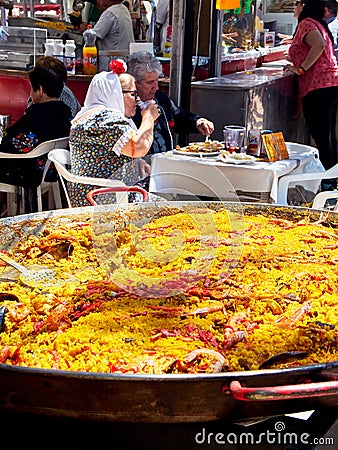 Chulapos eating Spanish Paella at festivity of San Isidro. Madrid. Editorial Stock Photo