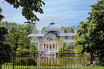 View of the beautiful Palacio de Cristal a conservatory located in El Retiro Park built in 1887 in Editorial Stock Photo