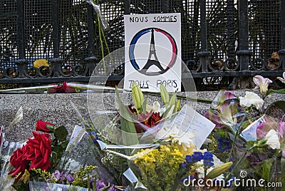 Madrid, Spain - November 15, 2015 - Flowers, candles and peace signs against terrorist attacks in Paris, in front of French Embass Editorial Stock Photo