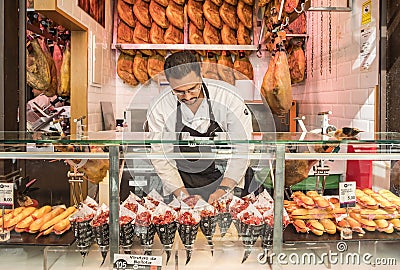 Madrid, Spain - October 7, 2017: Man Selling Iberico Ham at a Food Stall in a Market Editorial Stock Photo