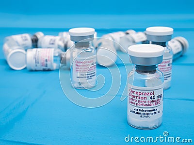 Omeoprazol bottles (stomach protector) with a pill inside to dilute in serum Editorial Stock Photo