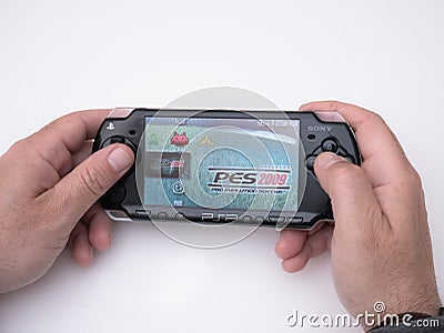 Young man holds in his hands the famous black Sony PSP Playstation Portable video game console Editorial Stock Photo