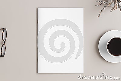 Magazine mockup with a cup of coffee, glasses and a lavender on the beige table Stock Photo