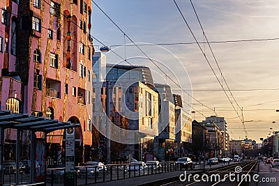 Magdeburg, Germany - January 28, 2024. Hundertwasserhaus Green citadel building on Breiter Weg street at warm glow Editorial Stock Photo