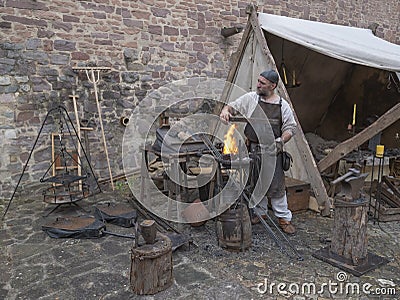 Magdeburg, Germany - 29.08.2014: Kaiser-Otto-Fest. Reconstruction of historical events of the city. Blacksmith from the middle Editorial Stock Photo