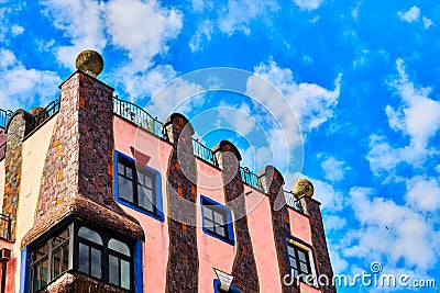 Side view of the green citadel with cloudy sky, a residential building, commercial building and hotel of the artist Friedensreich Editorial Stock Photo