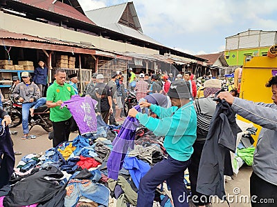 Magelang, October 12, 2021. Some people are choosing clothes to buy in second hand clothing sales. Editorial Stock Photo
