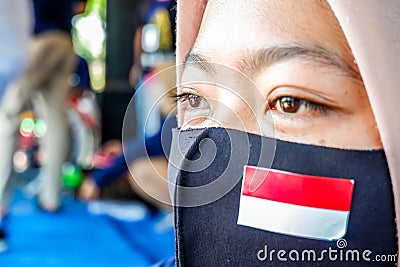 faces of young Indonesian women wearing masks to prevent the spread of covid-19 Editorial Stock Photo