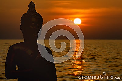 Magha Asanha Visakha Puja Day. Silhouette Buddha on blurred sunset background Stock Photo