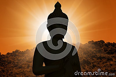 Magha Asanha Visakha Puja Day. Silhouette Buddha on blurred sunset background Stock Photo