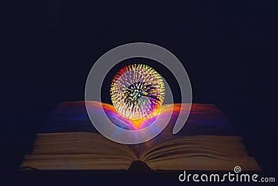 The magic ball of the fortuneteller, the witch, lies on the opened magic book Stock Photo
