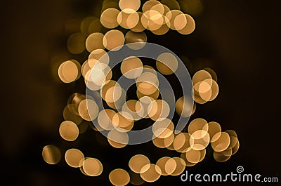 Magic holidays christmas defocused gold bright lights, bubbles and glitters in shape of christmas tree bokeh soft blur background Stock Photo