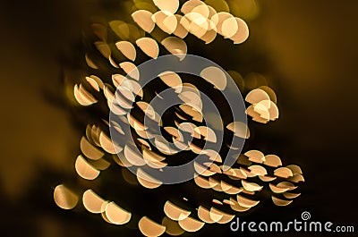 Magic holidays christmas defocused gold bright lights, bubbles and glitters in shape of christmas tree bokeh soft blur background Stock Photo